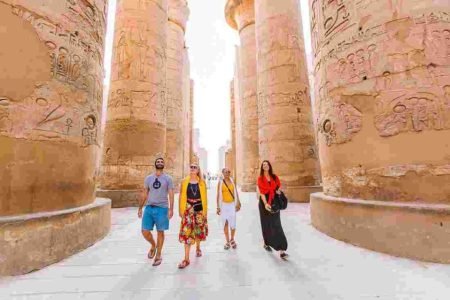 a group of people walking in karnak temple