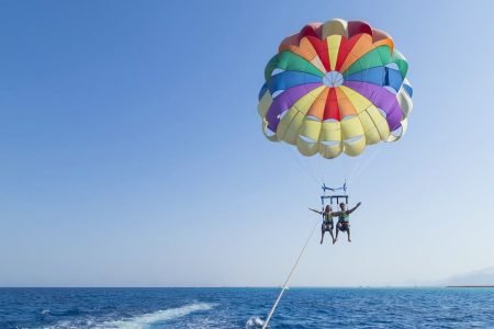 Parasailing in Hurghada offering stunning views of the Red Sea, desert, and mountains.